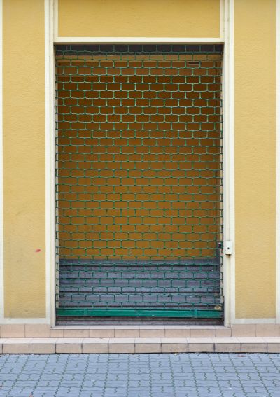 Spuściznę wyrob&oacute;w metalowych w krajobrazie naszego miasta dokumentują także pozostałości wyposażenia historycznych witryn sklepowych. Na zdjęciu zachowana in situ metalowa krata ograniczająca wejście do otwartego pasażu handlowego, znajdującego się na zapleczu lokali nowej siedziby firmy "I. Schaitter i Sp&oacute;łka" w kamienicy przy ul. Grunwaldzkiej 6 z lat 1937-1938.  Takie same kraty wypełniały wszystkie witryny sklepowe. Fot. Bogdan Szczupaj, Pola Antonina Słomińska, Galeria Fotografii Miasta Rzeszowa